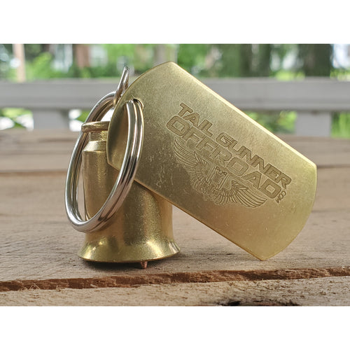 Brass bell made of a .50 cal shell with brass tag that says 
