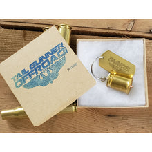 Load image into Gallery viewer, brass bell made of a .50 cal shell with brass tag that says &quot;Fun begins where pavement ends&quot;
